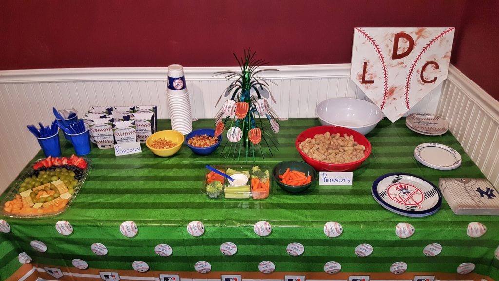 Baseball snack supply display with handmade wooden home plate sign
