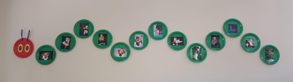Monthly baby photos in a Very Hungry Caterpillar decoration