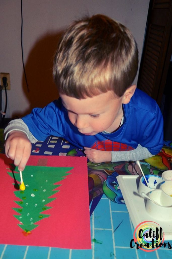 Painting with Q-tips on the Christmas tree