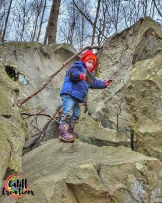 Climbing rocks in the woods