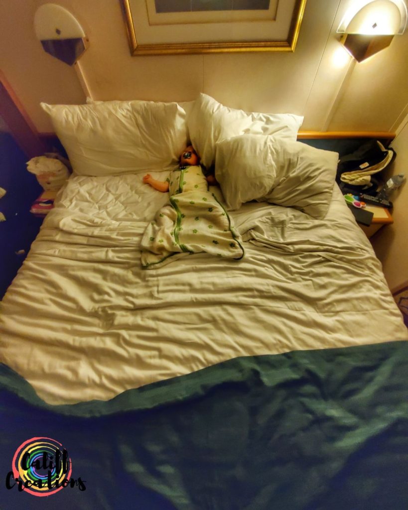 Our 16 month old sleeping on our bed in the cruise cabin