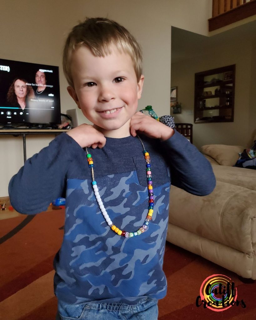My son showing off the necklace he made