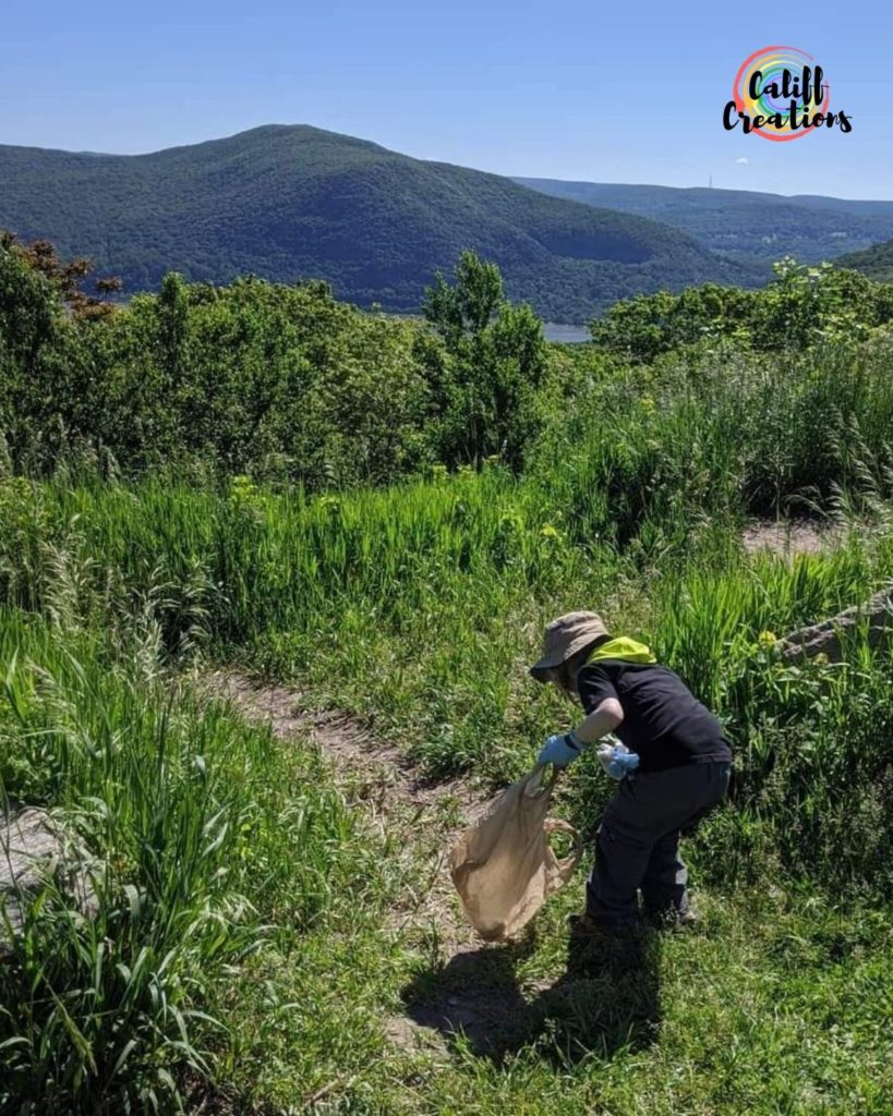 Local boy cleaning up garbage on Storm King Mountain