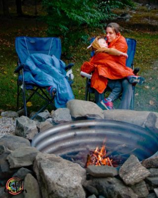 cuddled by the fire in get out gear camping blankets - gifts for moms
