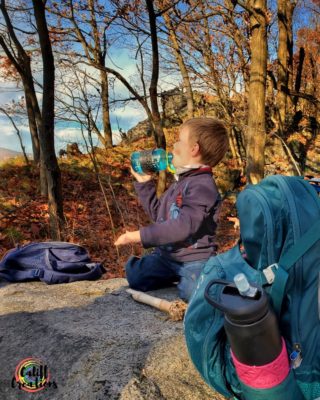 my son getting hydrated on the trail using his Arzarf sleeve - hydration
