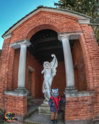 My son with the statue at the Vanderbilt Mansion