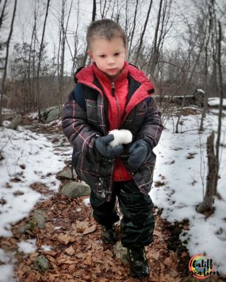 Gently carrying his snowball- one on one hiking with kids
