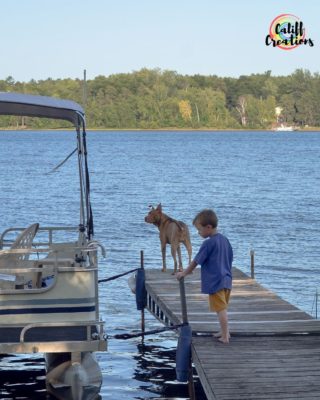 Boy and his dog on the dock